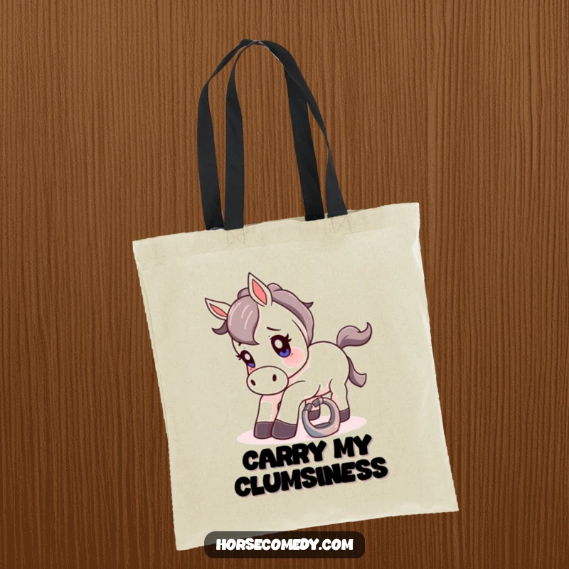 Funny tote bag with a cartoon horse comically off-balance after tripping over a small, shiny horseshoe.
